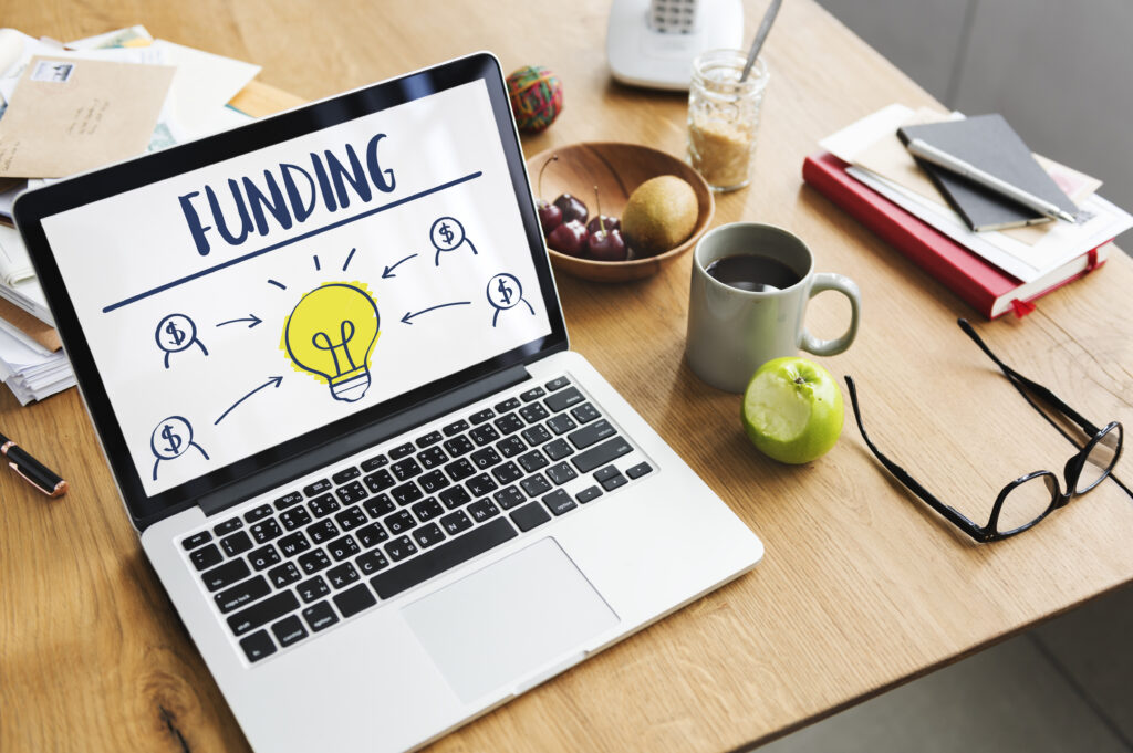 Funding application concept image - laptop and funding